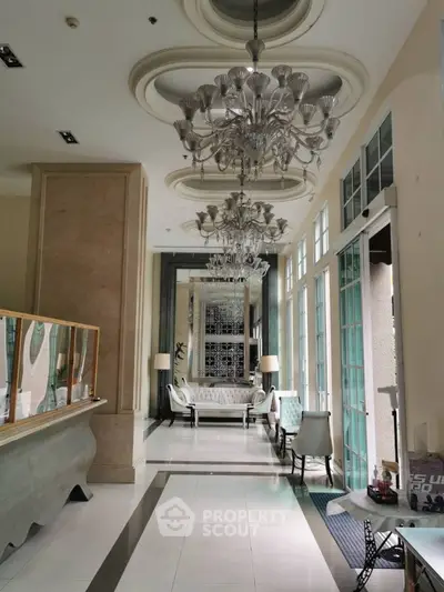 Luxurious lobby with elegant chandeliers and plush seating area