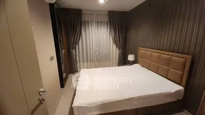 Modern bedroom with elegant decor and large bed in stylish apartment.