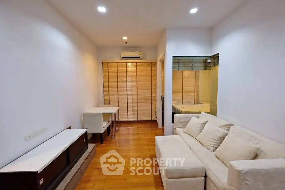 Cozy living room with wooden flooring and modern furniture in a stylish apartment.