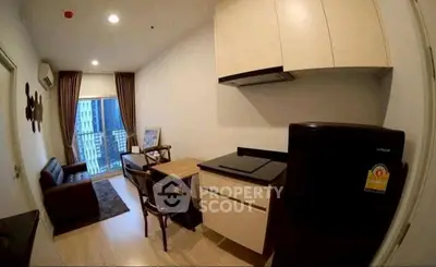 Modern apartment living room with compact kitchen and balcony view