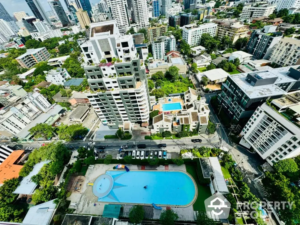 Stunning aerial view of urban residential area with pool and lush greenery