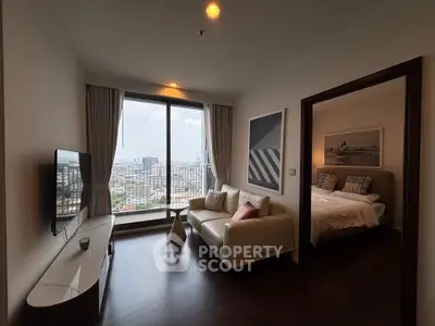 Modern living room with city view and adjacent bedroom in high-rise apartment.