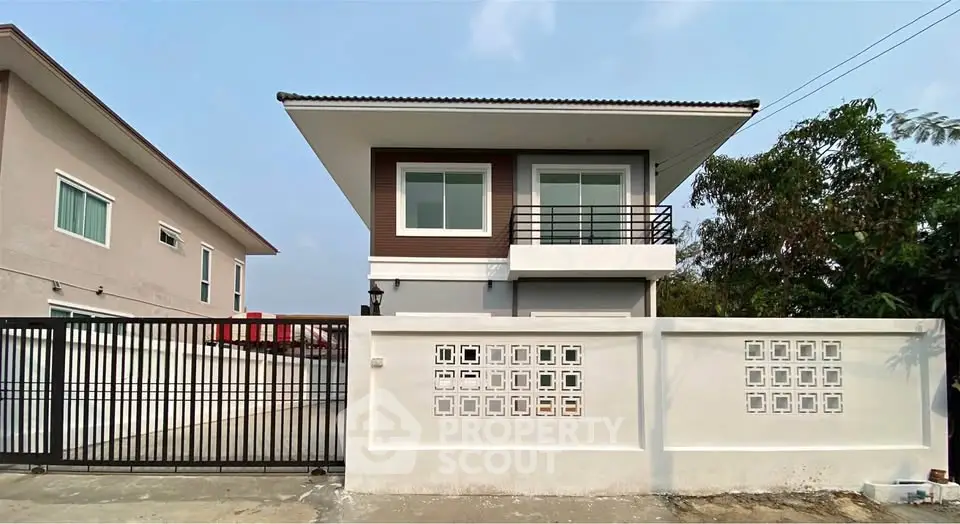 Modern two-story house with sleek design and gated entrance