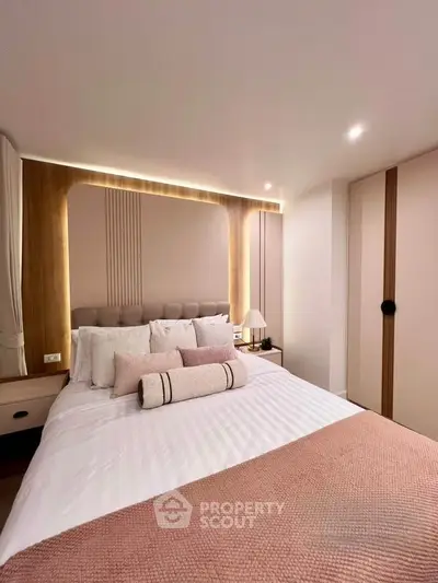 Luxurious bedroom with elegant lighting and stylish decor, featuring a cozy bed and modern design elements.