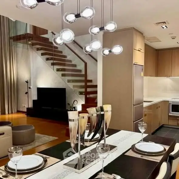 Luxurious open-plan living room with modern kitchen and elegant staircase