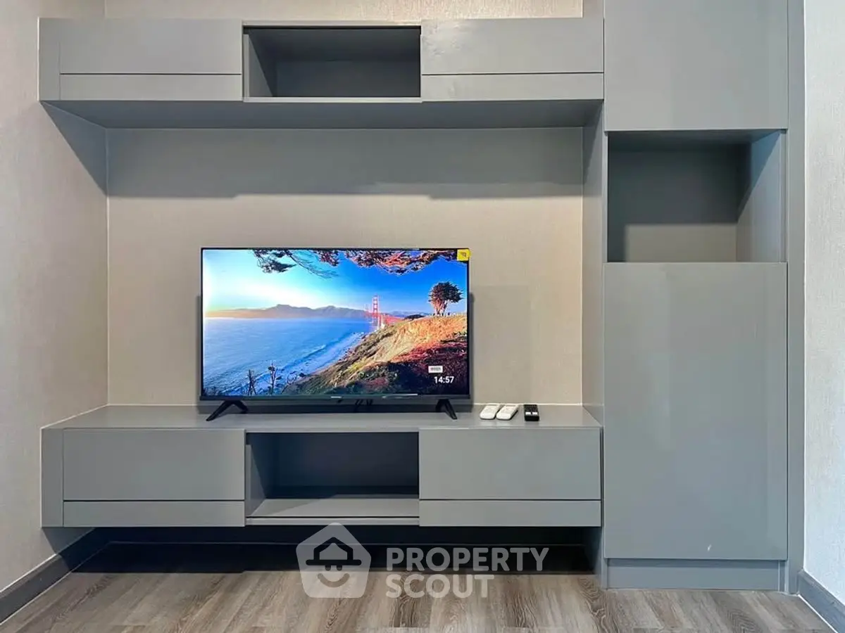 Modern living room with sleek gray entertainment unit and flat-screen TV