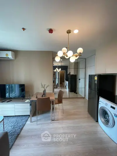 Modern living room with stylish furniture and in-unit washing machine