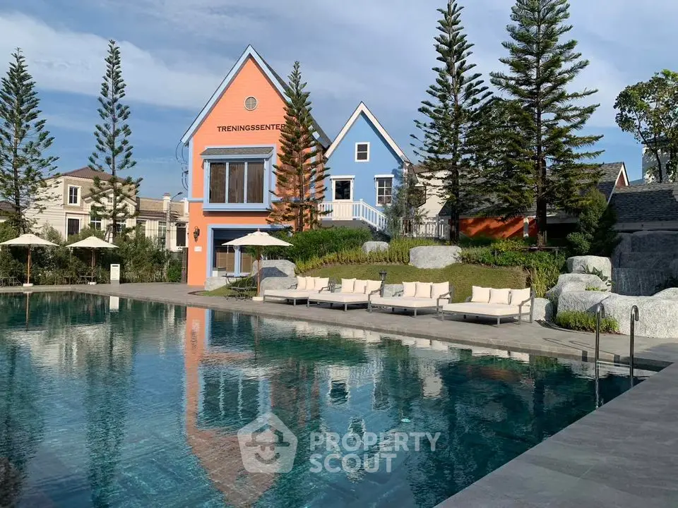 Luxurious poolside view with modern architecture and lush greenery