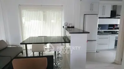 Modern open-plan kitchen and dining area with sleek design and natural light.