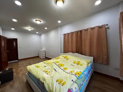 Spacious bedroom with cozy lighting and charming decor in a modern home.