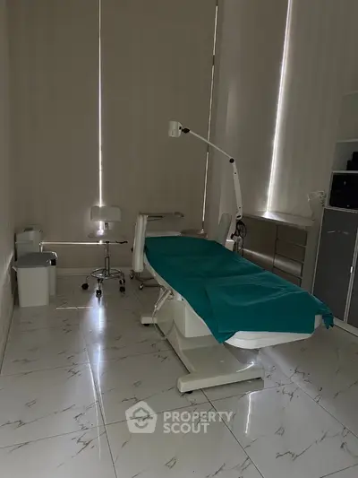 Modern medical examination room with sleek design and tiled flooring