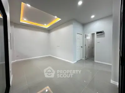 Modern minimalist interior with recessed lighting and glossy tile flooring.
