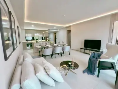 Luxurious open-plan living room with modern kitchen and elegant dining area.