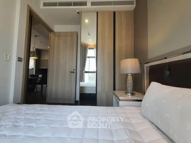 Modern bedroom with stylish decor and cozy ambiance in a contemporary apartment.