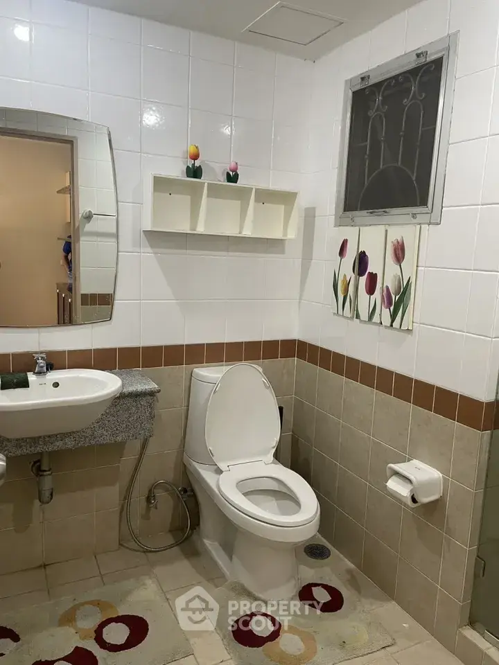 Charming bathroom with modern fixtures and decorative accents in a cozy home setting.