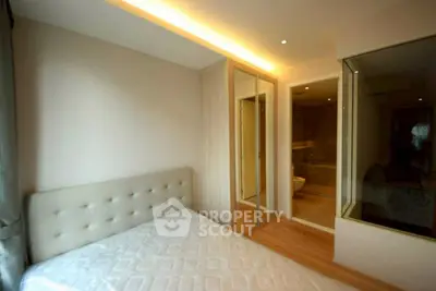 Modern bedroom with ensuite bathroom and glass partition in luxury apartment