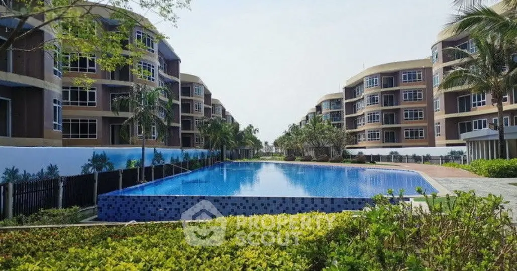 Luxurious residential complex with stunning pool and modern architecture.