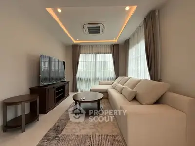 Luxurious living room with modern decor and large windows for natural light.