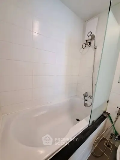 Modern bathroom with sleek bathtub and shower, perfect for relaxation and comfort.
