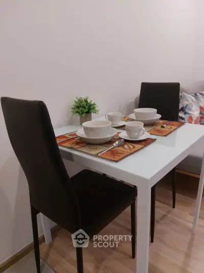 Cozy dining area with modern table and chairs, perfect for intimate meals.