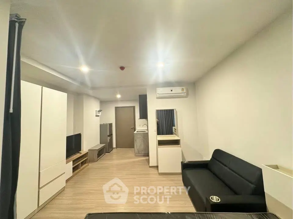 Modern living room with sleek furniture and ambient lighting in a contemporary apartment.