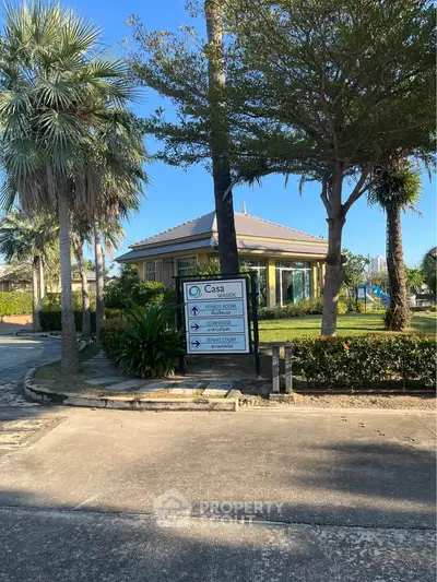 Charming residential building with lush greenery and clear blue sky.