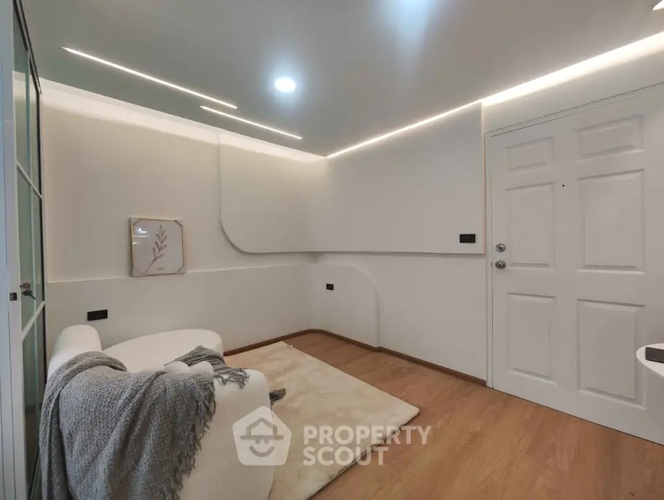 Modern minimalist room with cozy seating and elegant lighting