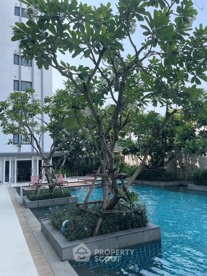 Luxurious apartment complex with a stunning outdoor pool and lush greenery, perfect for relaxation and leisure.