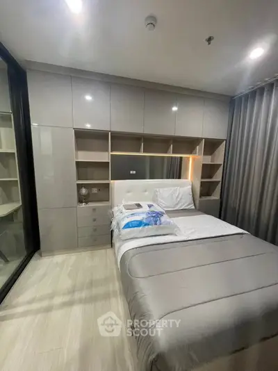 Modern bedroom with sleek built-in storage and cozy lighting