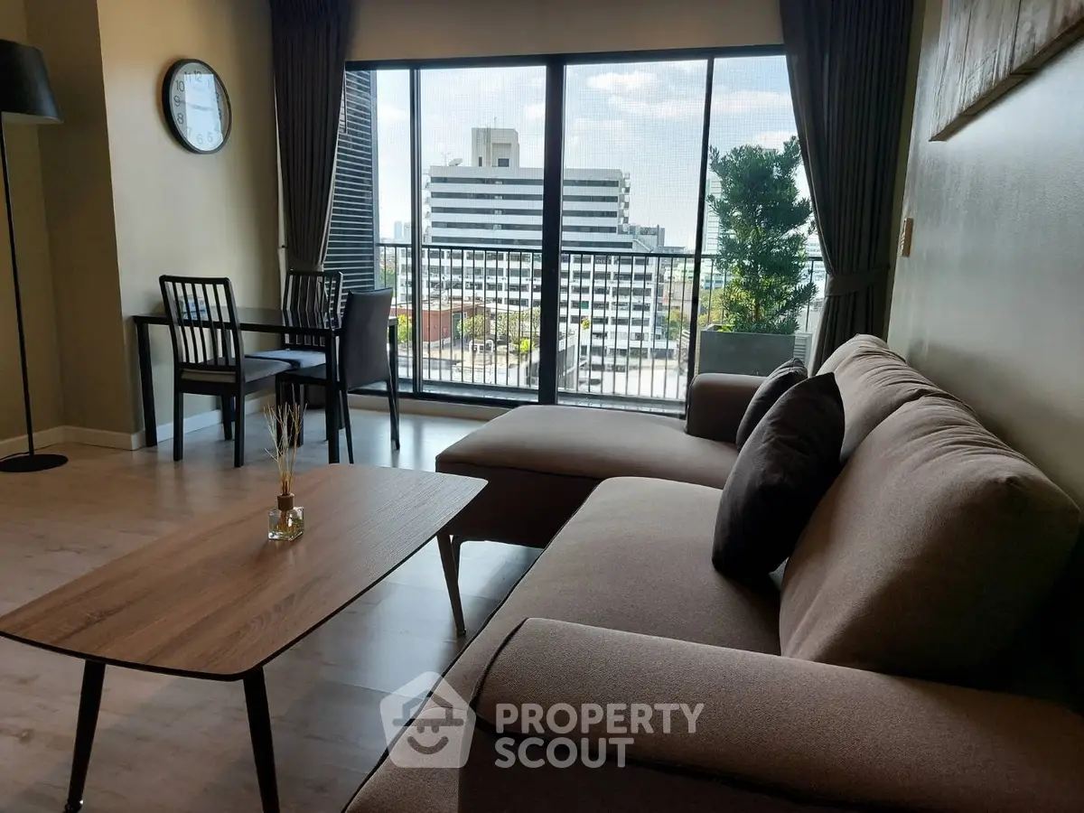 Spacious living room with modern furniture and city view balcony
