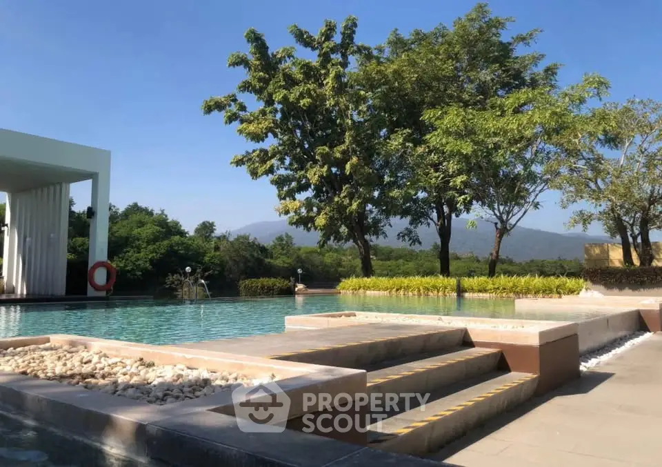 Luxurious outdoor pool with scenic mountain view and lush greenery