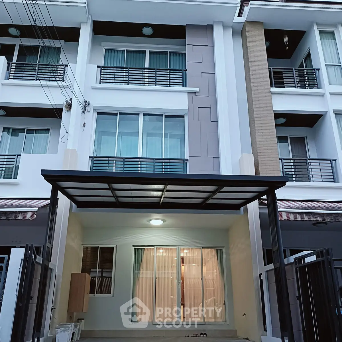 Modern multi-story townhouse with sleek facade and spacious balconies.