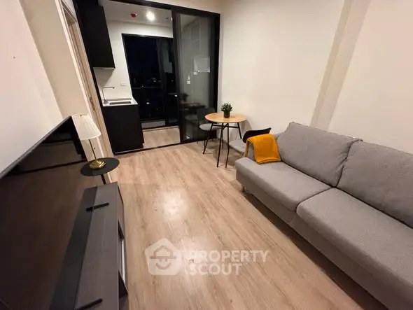 Modern living room with sleek furniture and balcony view