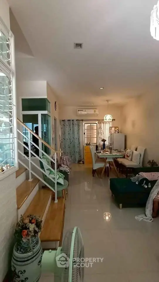 Charming open-layout living and dining area with cozy seating and modern decor.