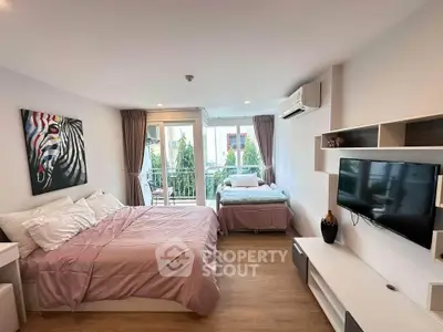 Spacious bedroom with balcony access and modern decor in a stylish apartment.