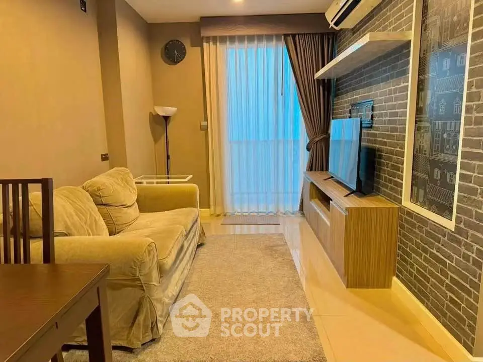 Cozy living room with plush sofa, wall-mounted TV, and elegant decor in modern apartment.