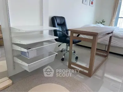 Modern bedroom with sleek desk and ergonomic chair, featuring minimalist shelving and natural light.