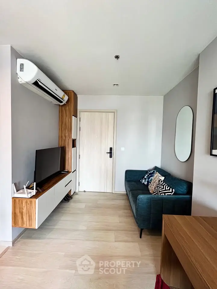 Modern living room with sleek furniture and air conditioning, perfect for urban living.
