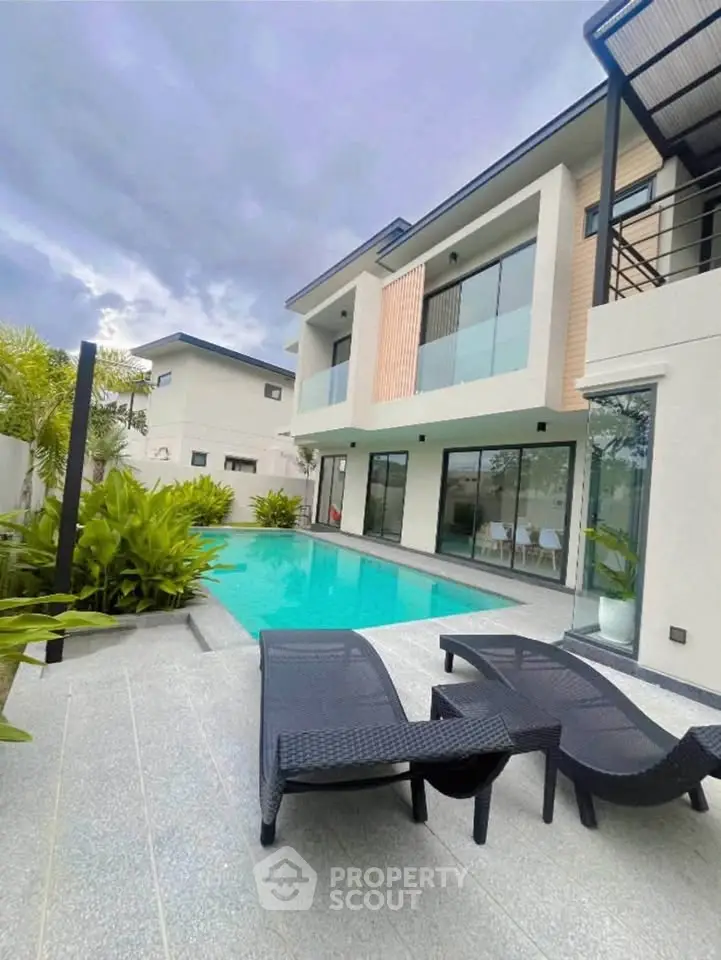 Luxurious modern villa with private pool and stylish outdoor lounge area, perfect for relaxation and entertainment.