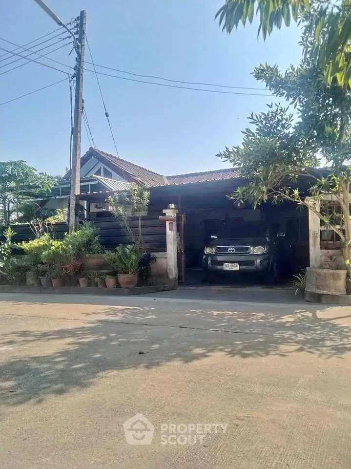 Charming suburban home with lush greenery and spacious driveway, perfect for family living.