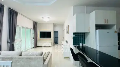 Spacious modern living room with open kitchen and sleek design