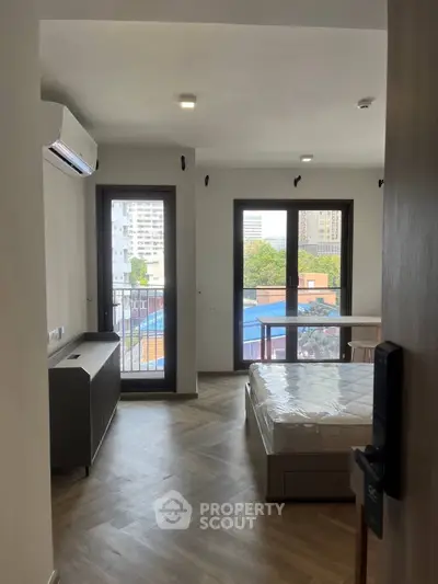 Modern bedroom with balcony view in urban apartment