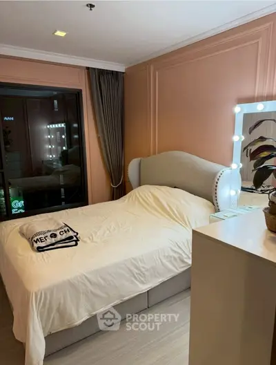 Cozy bedroom with elegant decor and illuminated vanity mirror