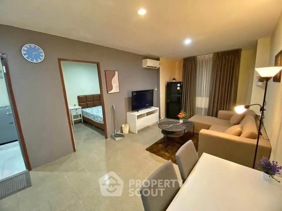 Modern living room with cozy seating and dining area, featuring stylish decor and ample natural light.