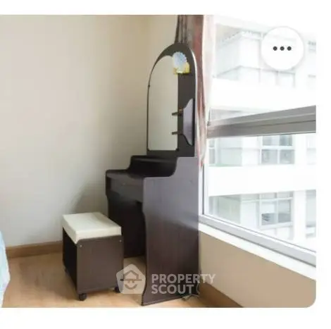 Elegant bedroom corner with vanity and large window view