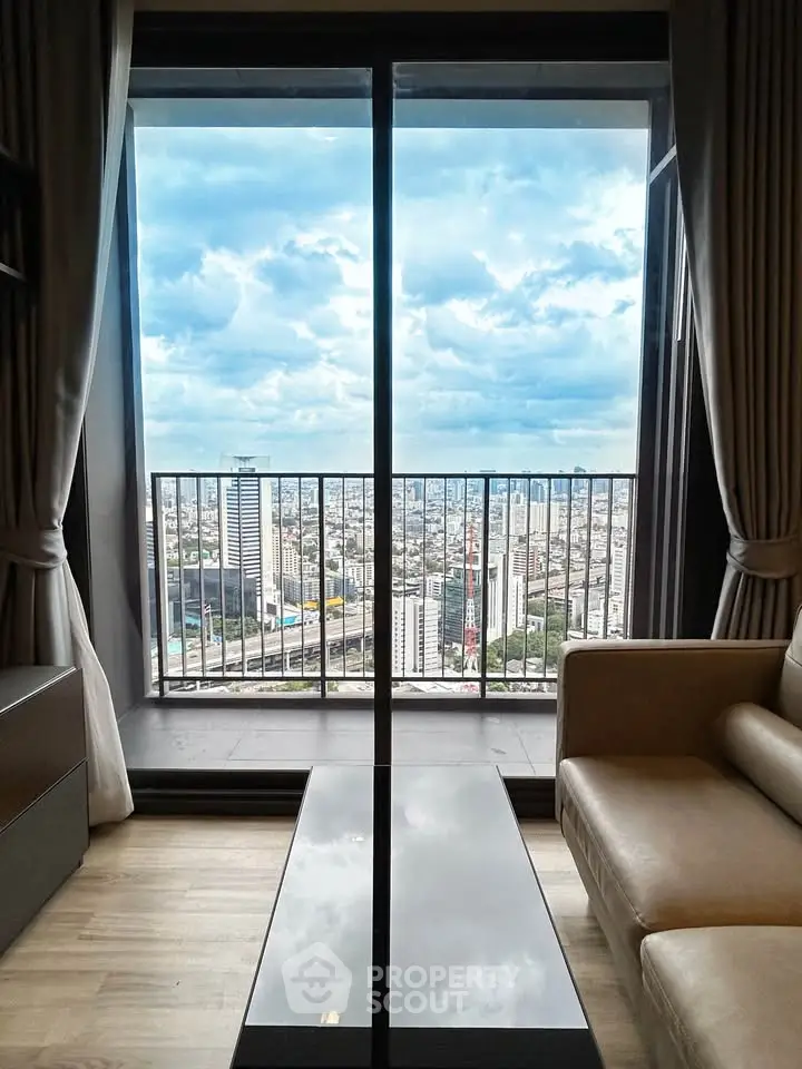 Stunning city view from modern living room with floor-to-ceiling windows and elegant decor.