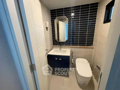 Modern bathroom with sleek design and stylish dark blue tiles