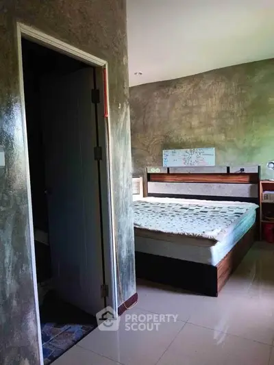 Cozy bedroom with modern design and stylish decor, featuring a comfortable bed and sleek flooring.