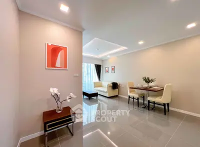 Modern living room with elegant decor and dining area in open layout apartment.