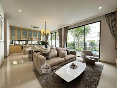 Luxurious open-plan living room with elegant decor and large windows overlooking a lush garden.